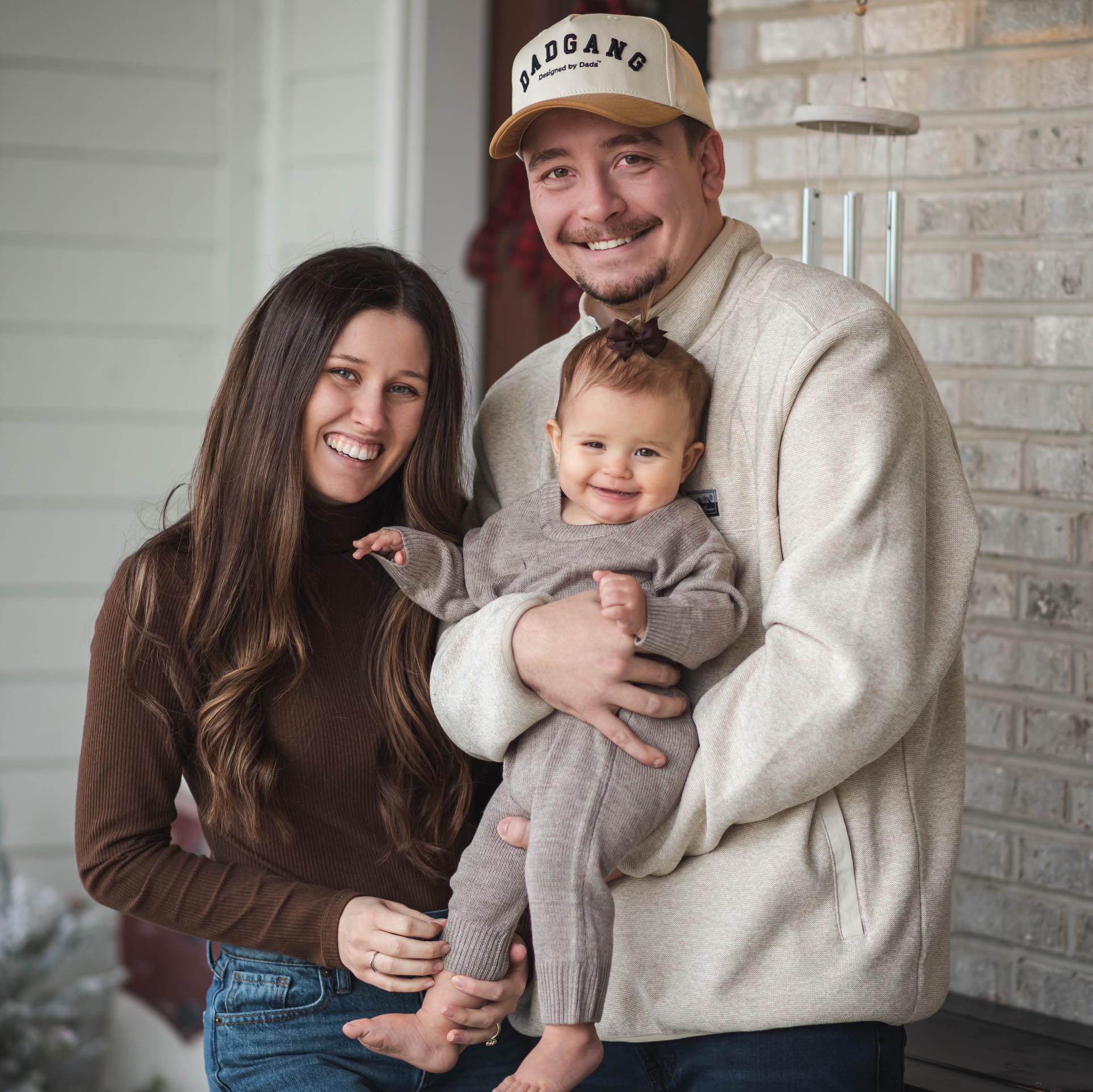 Image of groomsman Austin with his wife Lexi and their daughter Emmy.